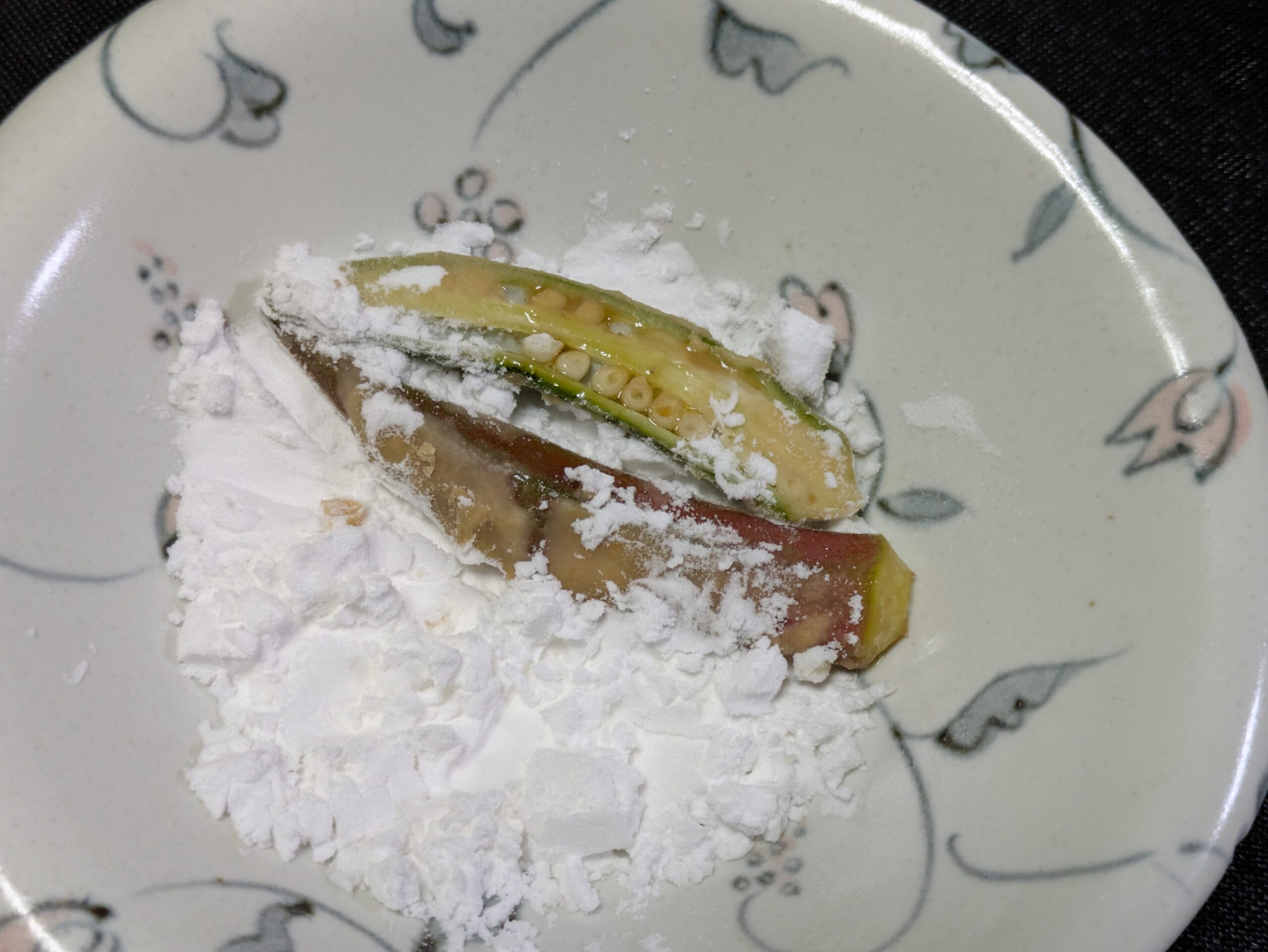 下味をつけたオクラに片栗粉をまぶしている様子