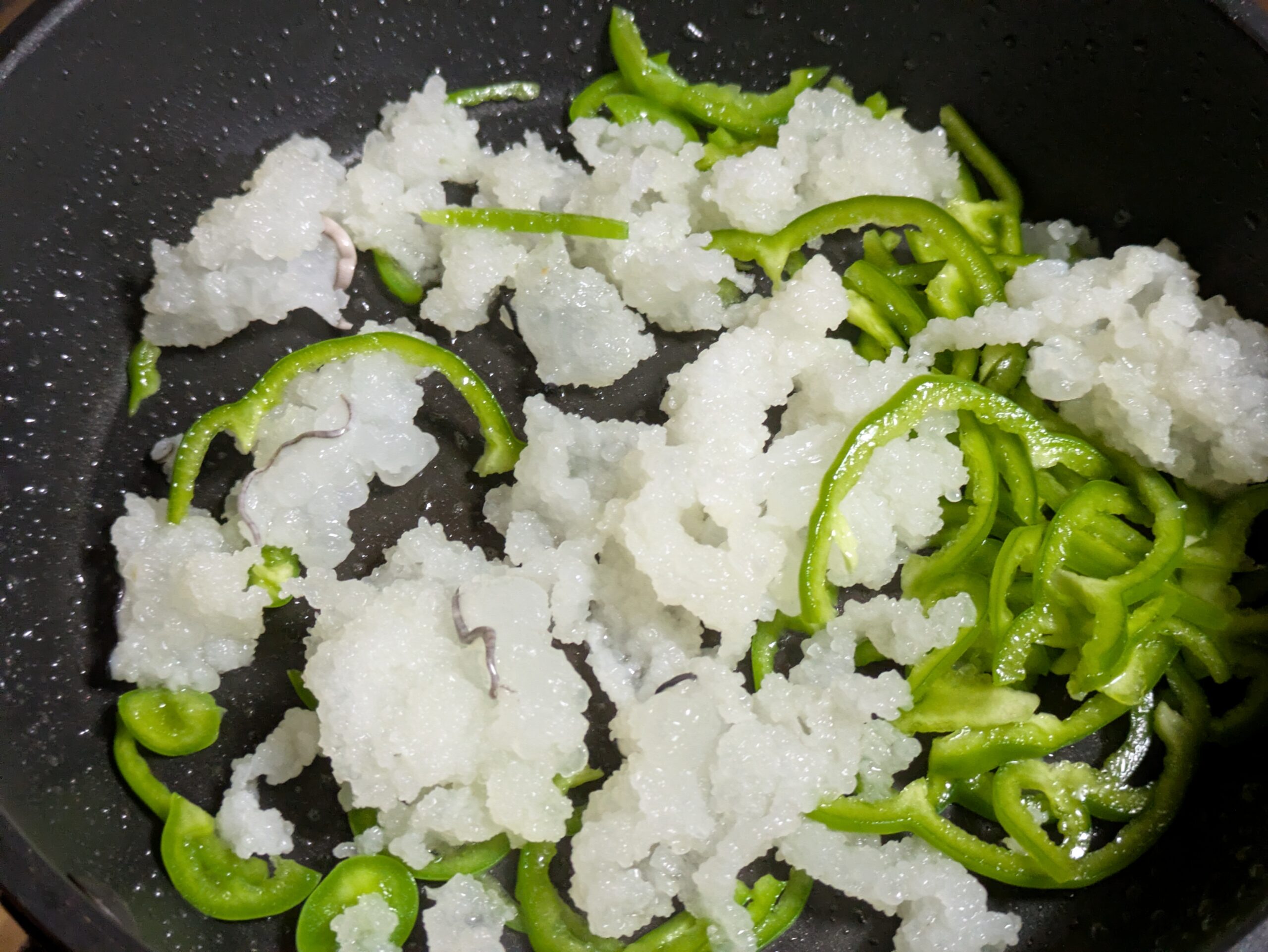 フライパンでさらし鯨とピーマンを炒めているところ